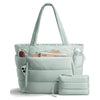 A light mint green quilted puffy tote bag with a laptop sleeve and shoulder strap.