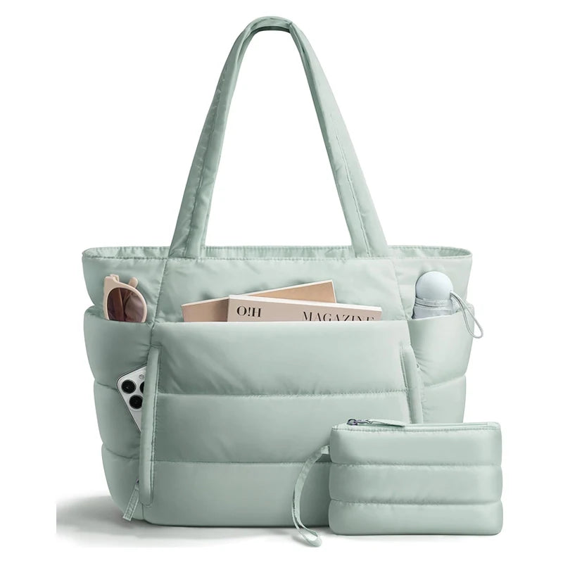 A light mint green quilted puffy tote bag with a laptop sleeve and shoulder strap.