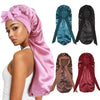 A collection of satin sleep bonnets in pink, teal, black, and maroon shown with a model.