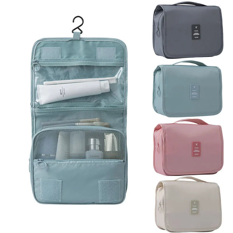 A set of four gray and pink travel makeup bags with hanging hooks and mesh pockets for organizing toiletries.