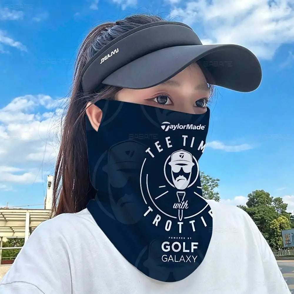 A person wearing a navy blue face mask with a golf theme is looking towards the camera under a bright sky.