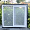 A white sliding window with a clear mesh screen installed in a black frame, set against green foliage.