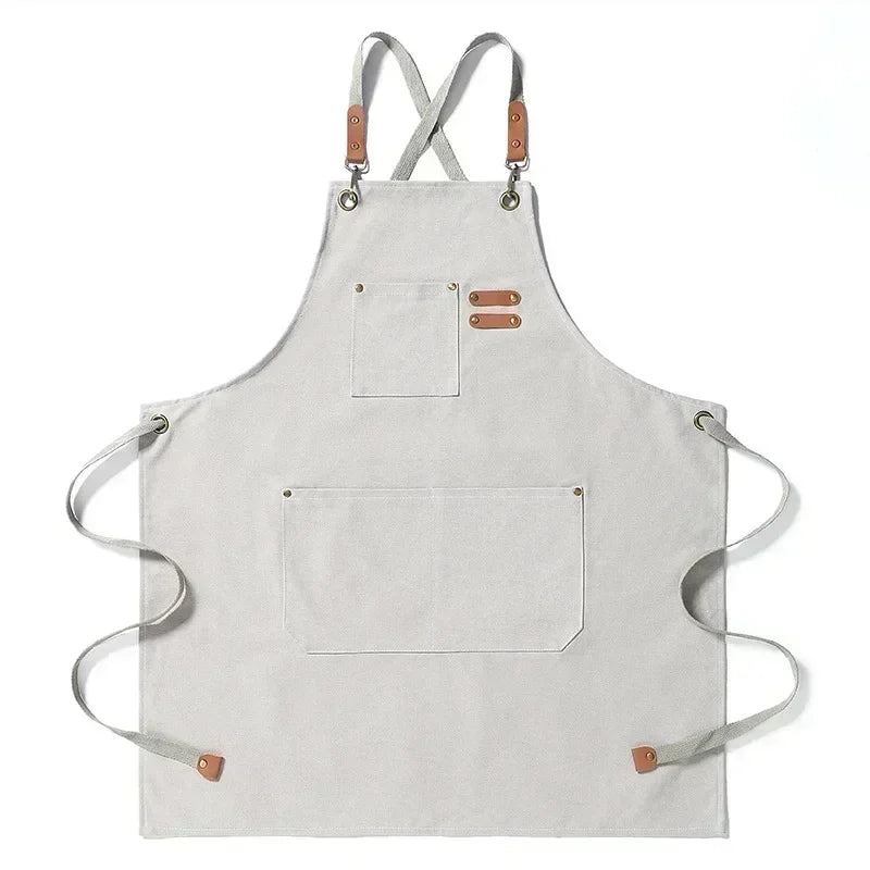 Light gray cotton canvas apron with cross-back straps and two patch pockets