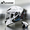 A white and black flip-up motorcycle helmet is displayed on a gray surface.