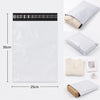 A white self-sealing mailing bag with a black seal strip and a beige fabric tag is shown next to a folded white bag.