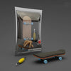 A wooden finger skateboard is shown inside its clear plastic packaging with a wooden board visible.