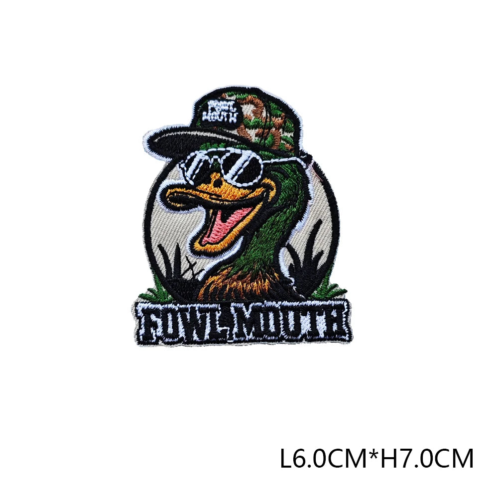 A black embroidered hunting patch featuring a stylized owl face wearing sunglasses and text.