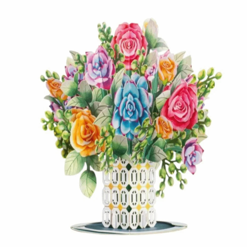 A vibrant bouquet of pink, blue, and orange roses and greenery displayed in a white decorative vase.