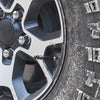 Close-up view of a tire rim with an adjustable auto-stop tire deflator kit installed.