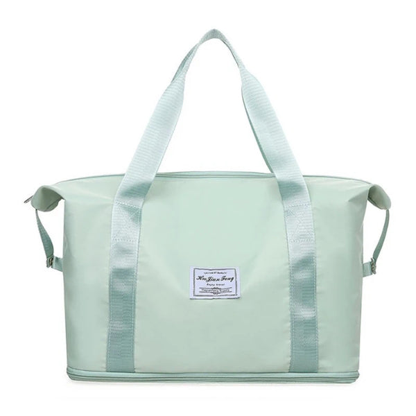 Bolso plegable impermeable de color verde menta claro con correas azul claro.