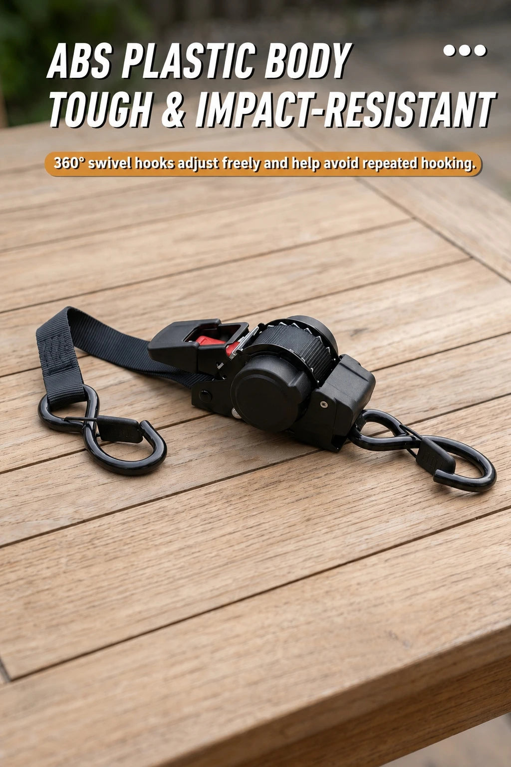 Black ABS plastic body auto-retractable ratchet tie-down straps with swivel hooks on a wooden surface.