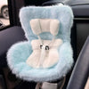 A light blue faux fur seat car vent decoration with white padding and straps.