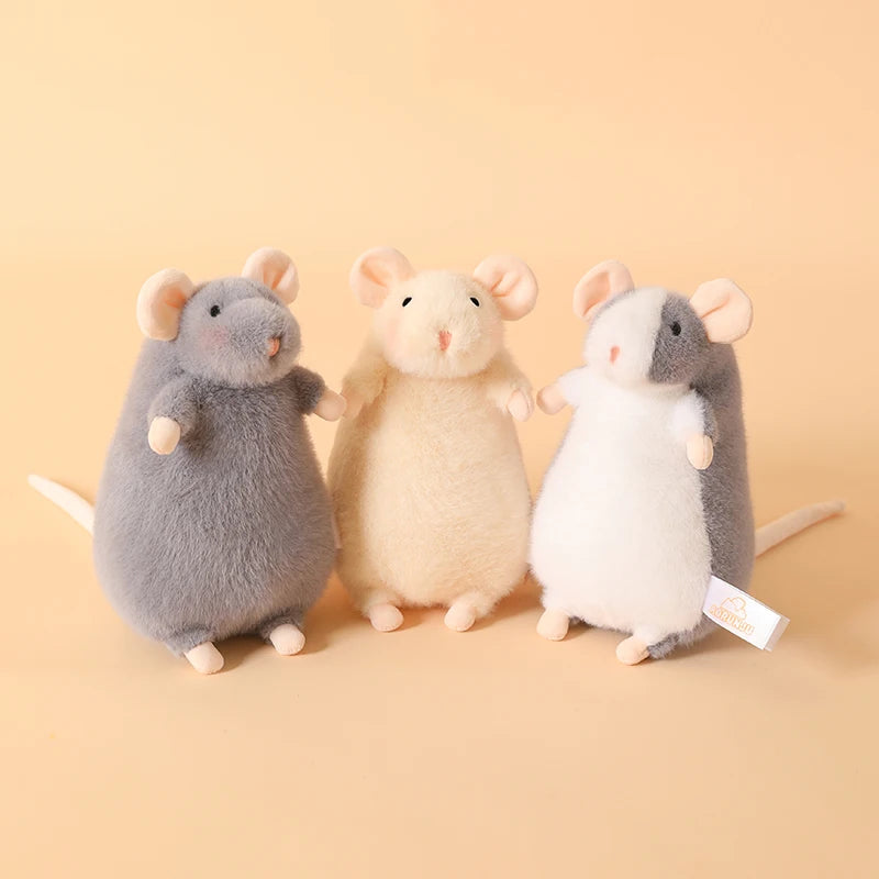Three adorable plush mouse stuffed animals in gray, beige, and white sitting on a light background.