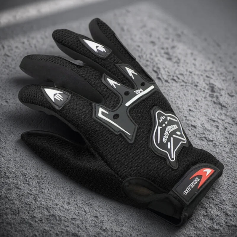 A pair of black full finger nylon riding gloves with anti-slip grips resting on a gray textured surface.