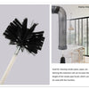 A black smoke pipe brush with a long extension rod shown next to a modern interior setting.