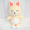 A soft yellow and white plush toy resembling a fox or canine character with closed eyes.