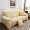 A light beige silky soft stretchable sofa cover for pet owners displayed on a modern living room sofa.