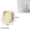 A light beige, wavy-edged silicone mold for concrete candle holders or plaster decor.