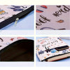 A bookish fabric book sleeve with a zipper featuring a cat and books design on the cover.