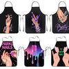 A set of black professional nail artist aprons featuring various glitter and pink nail art designs.