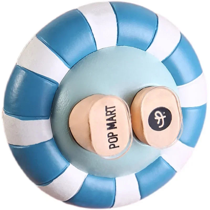 A round adhesive patch with blue and white stripes, featuring a circular center and a small circular emblem.