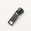 A black universal zipper slider repair kit with three different sized sliders displayed on a white background.
