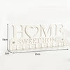 White wooden sign with the words HOME SWEET HOME and a heart design, featuring decorative serrated edges.