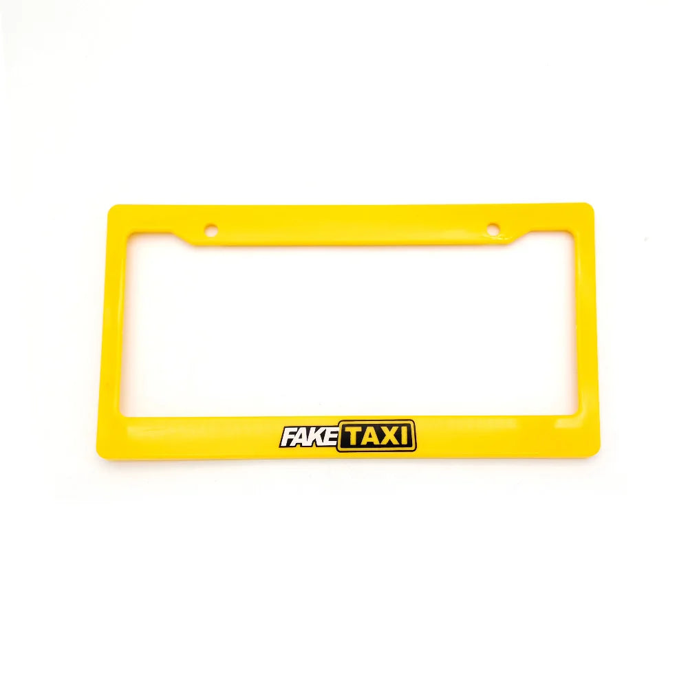 A yellow racing style license plate frame with the text FAKE TAXI on it.
