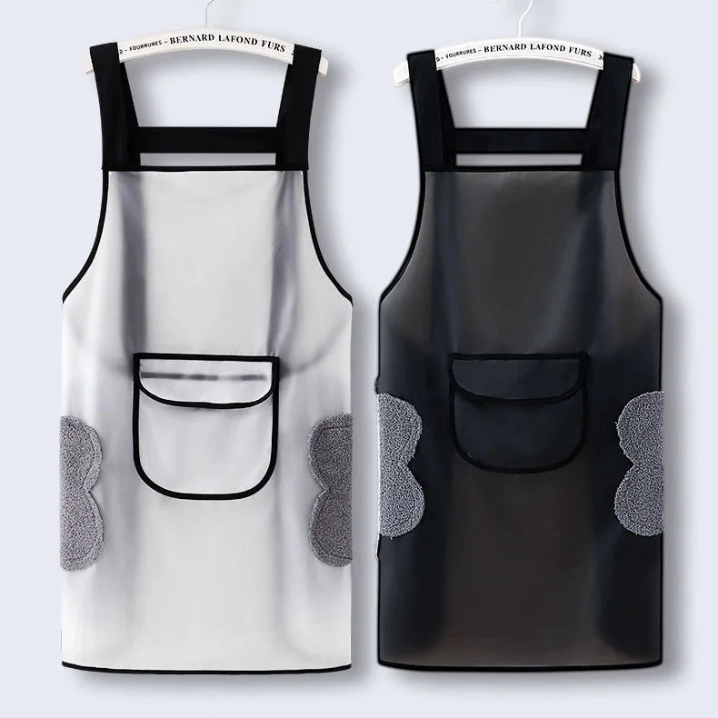 A pair of black waterproof kitchen aprons with mesh pockets and gray accents hanging on a rack.