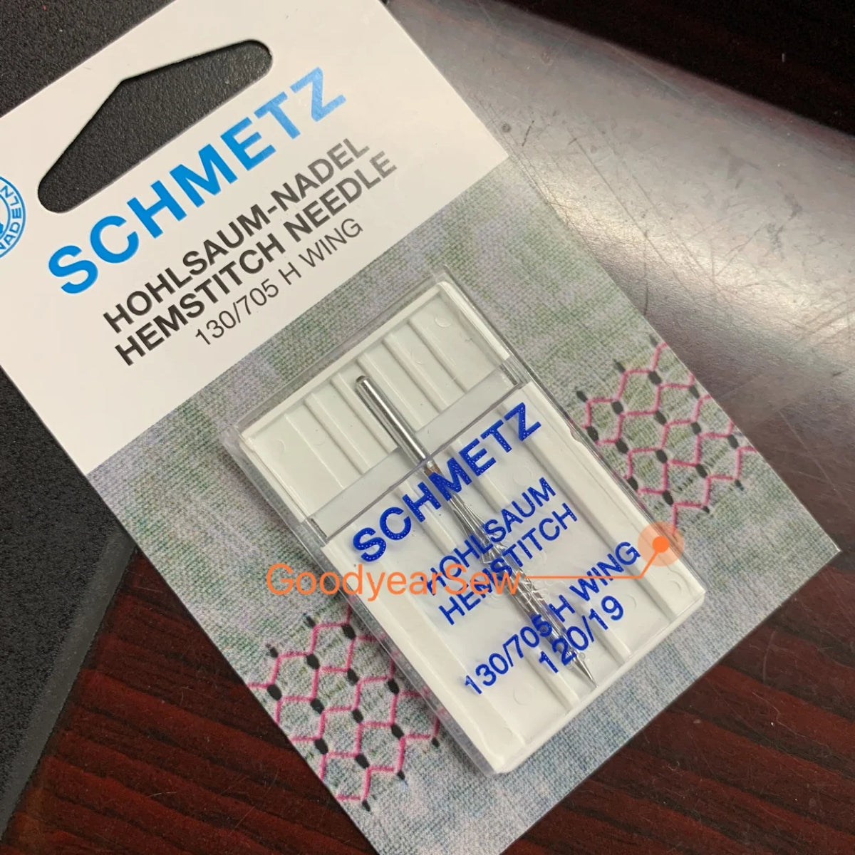 A packet of Schmetz Hohlsaum-Nadel Hemstitch Needle 130/705 H wing needles for sewing machines.