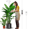 A woman is adjusting a full spectrum LED grow light with a timer and adjustable stand for indoor plants.