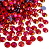 A pile of various red and pink rhinestones for DIY crafts and clothing decoration
