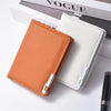 A vertical slim leather wallet in orange and off-white colors resting on a white surface.
