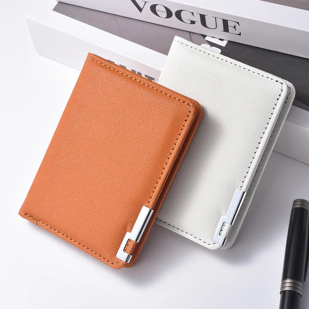 A vertical slim leather wallet in orange and off-white colors resting on a white surface.