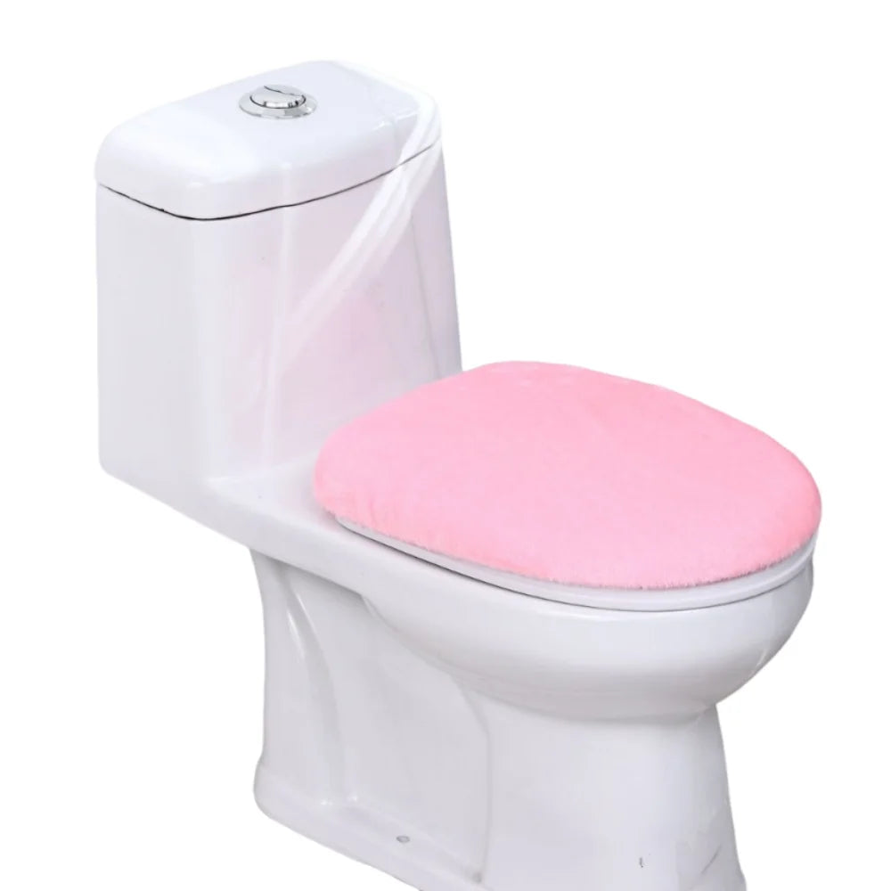 A white toilet with a pink soft flannel seat cover installed.