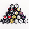 A collection of ten pairs of 1:64 scale alloy car wheels and tires arranged in a pyramid formation.