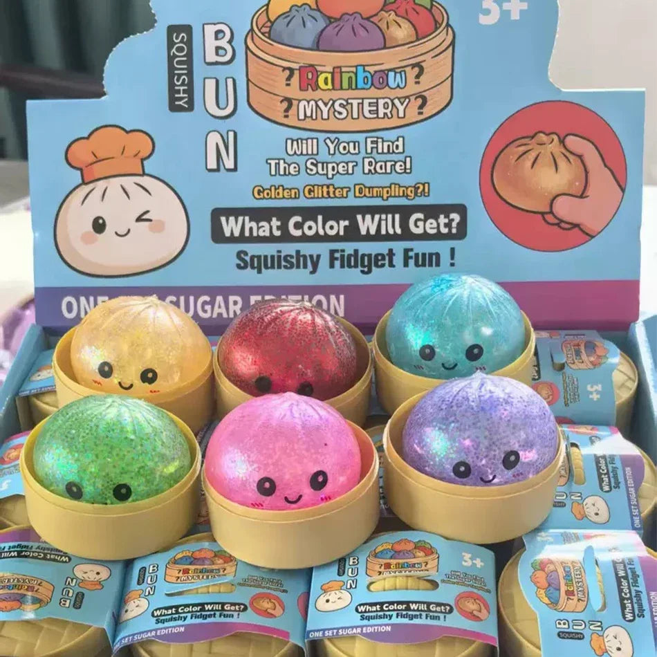 Eine Box mit glitzernden, quetschbaren Fidget-Spielzeug-Dumplings in verschiedenen Farben.