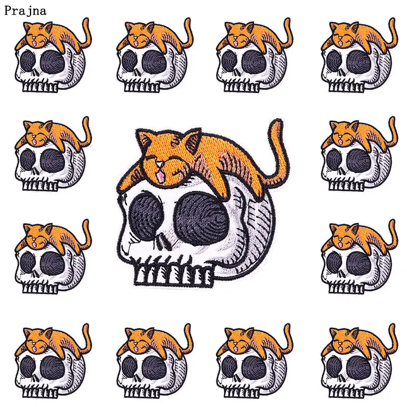 A set of ten embroidered iron-on patches depicting orange cats with skull faces.