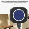 A black foam isolation shield with a blue circle is mounted on a stand, positioned above a wooden table.