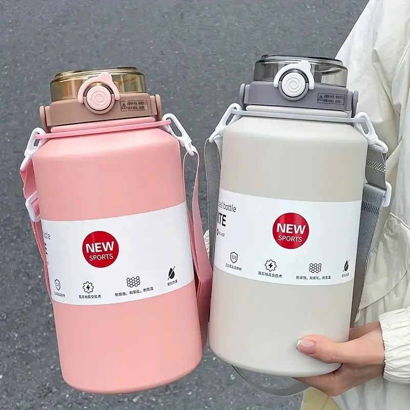 A pink insulated stainless steel tumbler with a lid and straw is held by a person.