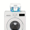 A white automatic pop-up laundry pod holder with a clear container of colorful laundry pods sits on top of a white washing ma
