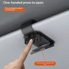 A hand is pressing a one-handed press to open mechanism on a car sunshade magnetic glasses holder.