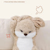 A fluffy, light brown rabbit plush toy with white accents sitting on a light-colored sofa.