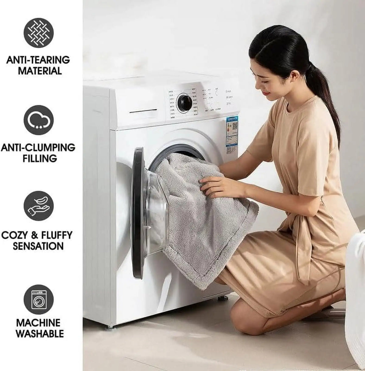 A woman is folding a gray blanket inside a white washing machine, demonstrating its anti-tearing and cozy features.