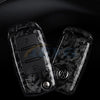 A pair of black carbon fiber car key covers for VW and Skoda models displayed on a dark surface.