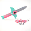 A set of four pink and teal dagger key necklaces with silver charms and a green blade.