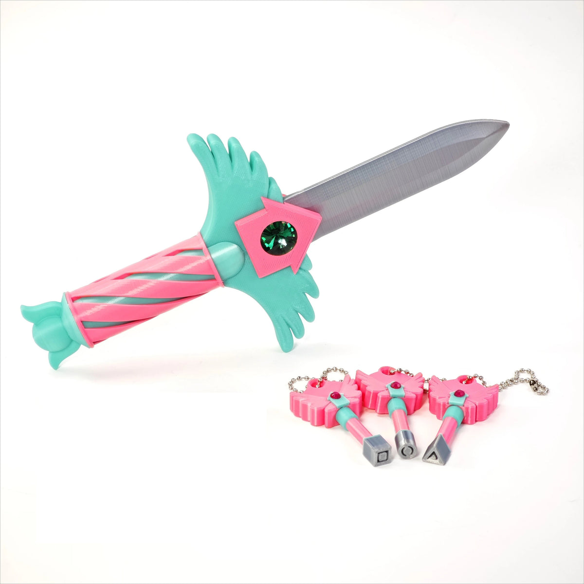 A set of four pink and teal dagger key necklaces with silver charms and a green blade.