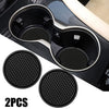 Deux sous-verres en silicone noirs anti-dérapants pour porte-gobelets de voiture avec un support en plastique noir.
