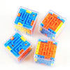 Three transparent plastic cubes filled with blue, orange, and yellow maze puzzle pieces.