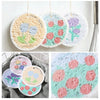 A pack of four cotton scouring sponges in various colors including yellow, green, and purple.